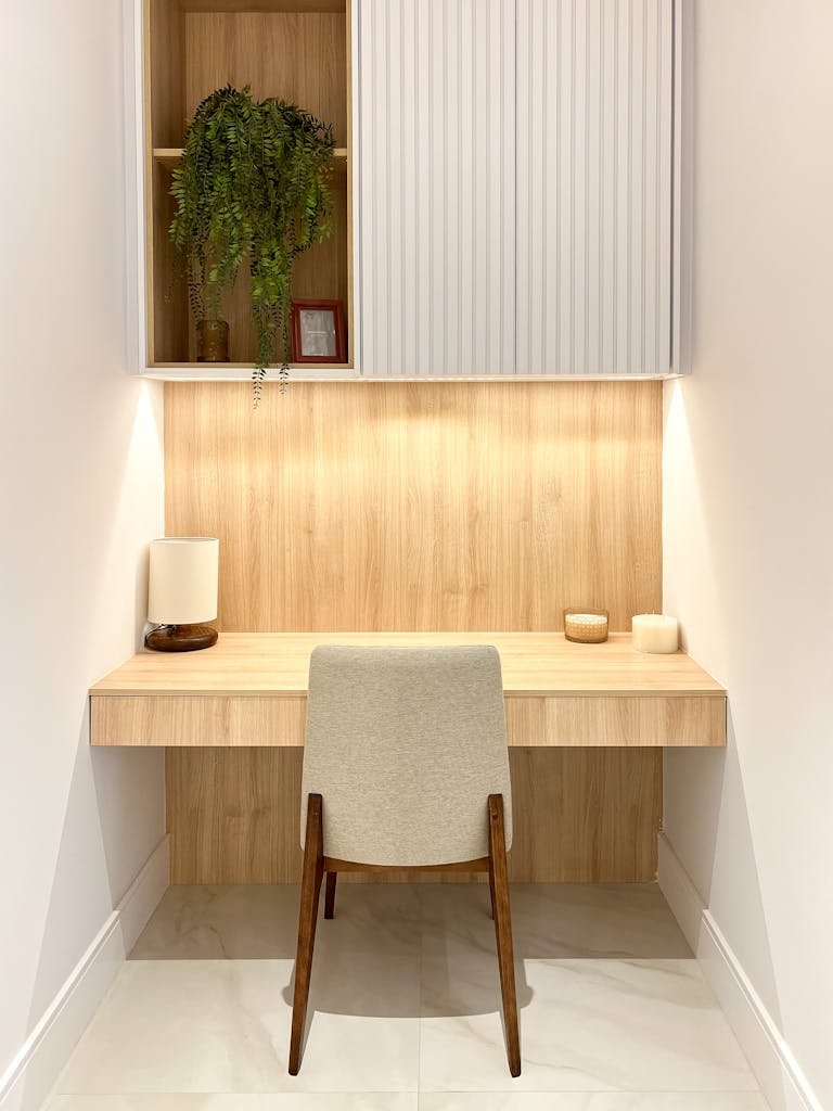 A small desk with a chair and a plant